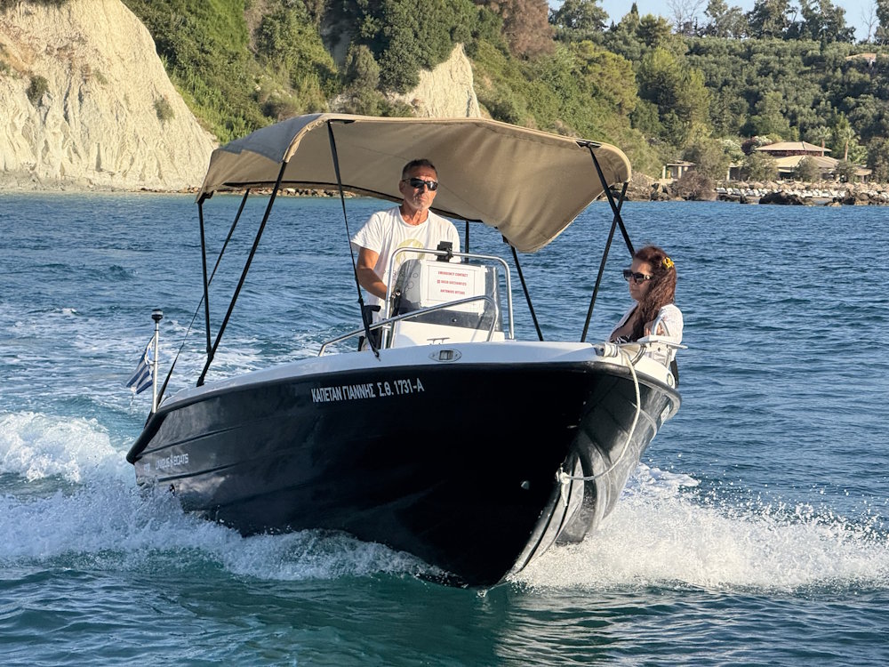 Skipper steering a Gerani Boats rental in Zakynthos